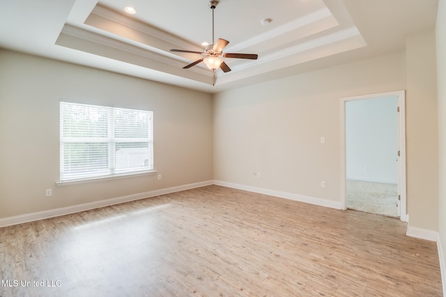15581 Ollie Ln, Biloxi, MS 39532 - spare room with a tray ceiling, ornamental molding, a ceiling fan, light wood finished floors, and baseboards