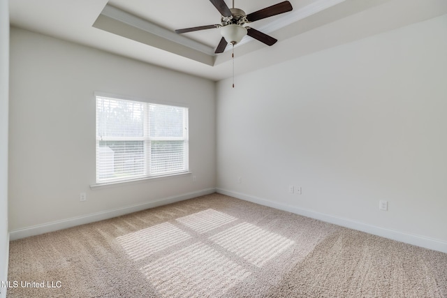 15581 Ollie Ln, Biloxi, MS 39532 - unfurnished room featuring a tray ceiling, carpet flooring, and baseboards