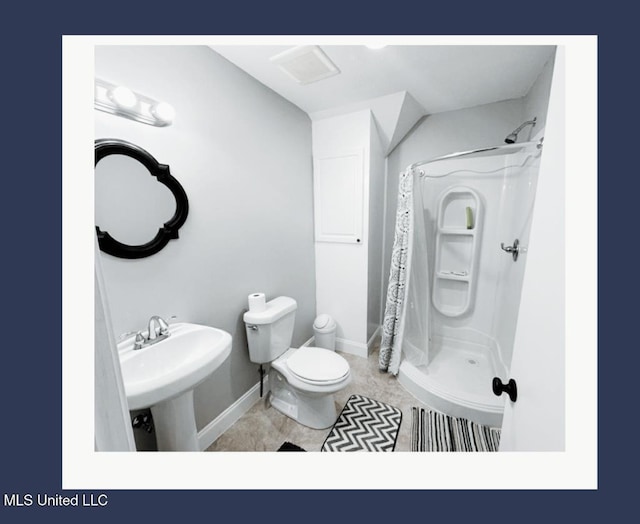 bathroom featuring tile patterned flooring, sink, a shower with curtain, and toilet