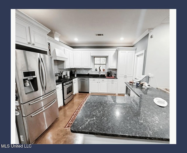 kitchen featuring crown molding, stainless steel appliances, custom range hood, and white cabinets