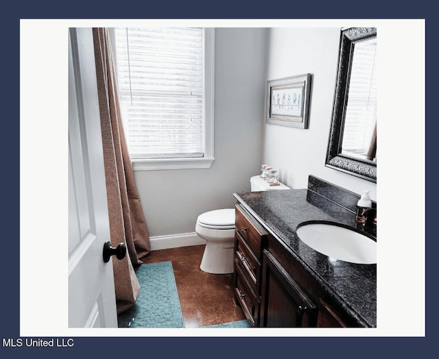 bathroom featuring vanity and toilet