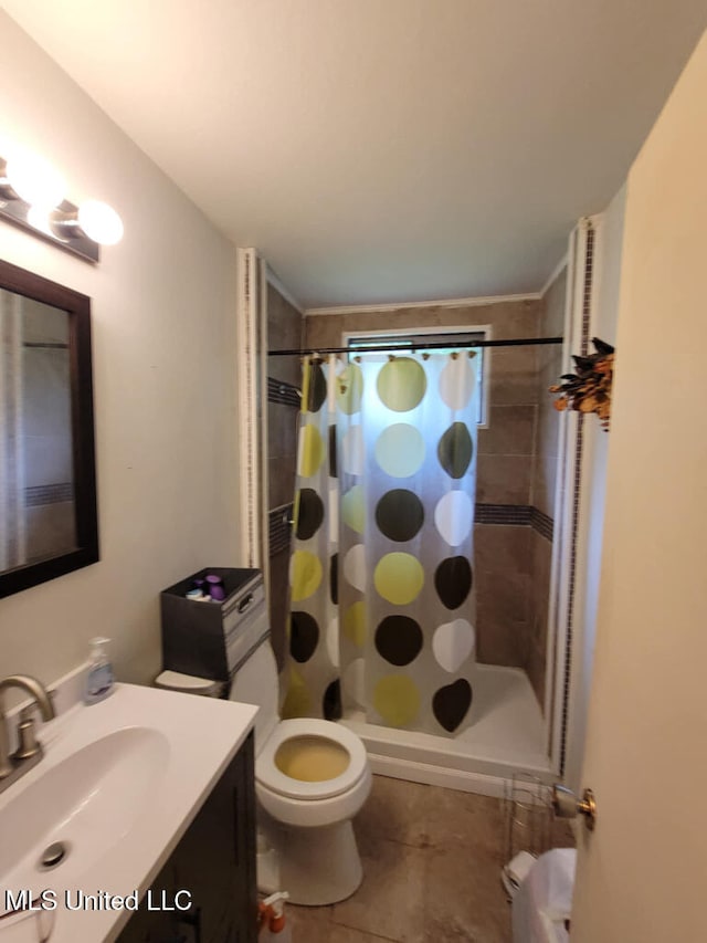 full bathroom featuring toilet, a stall shower, vanity, and tile patterned flooring