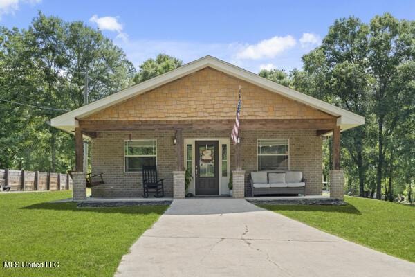 284 Osborn Moody Rd, Poplarville, MS 39470 - view of front of house with a porch, brick siding, and driveway