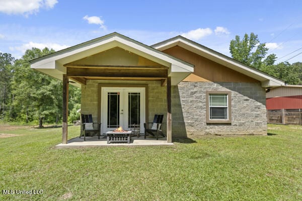284 Osborn Moody Rd, Poplarville, MS 39470 - rear view of house featuring a yard, french doors, a patio area, and concrete block siding