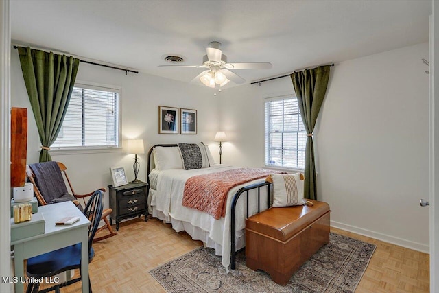 bedroom featuring a ceiling fan, visible vents, and baseboards