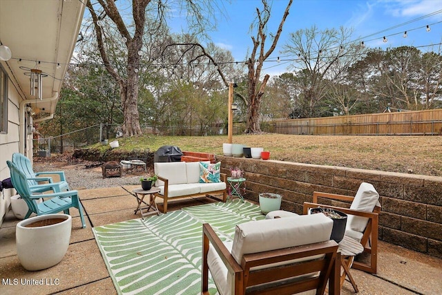 view of patio with an outdoor living space with a fire pit and a fenced backyard