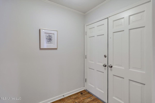 entrance foyer with ornamental molding, dark wood finished floors, and baseboards