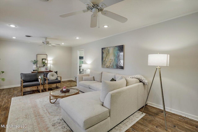 living room featuring baseboards, wood finished floors, and recessed lighting