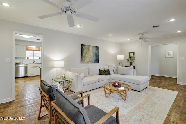 living room with baseboards, ceiling fan, wood finished floors, and recessed lighting