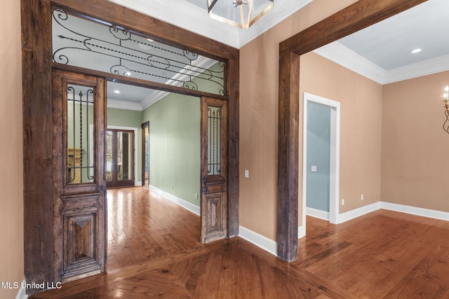 foyer entrance with ornamental molding and hardwood / wood-style floors