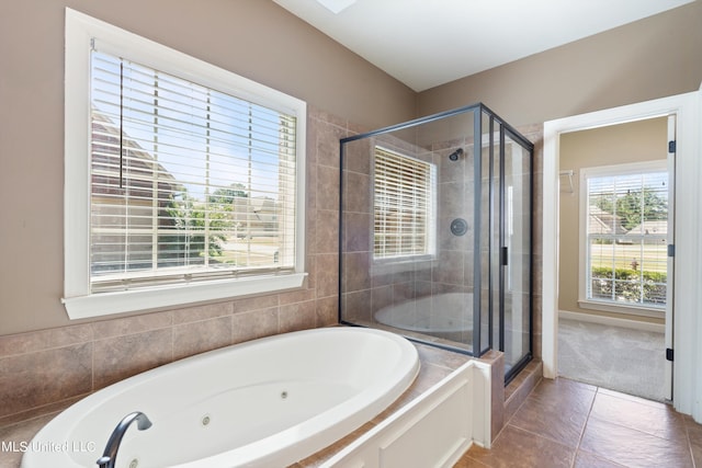 bathroom featuring tile patterned floors and separate shower and tub