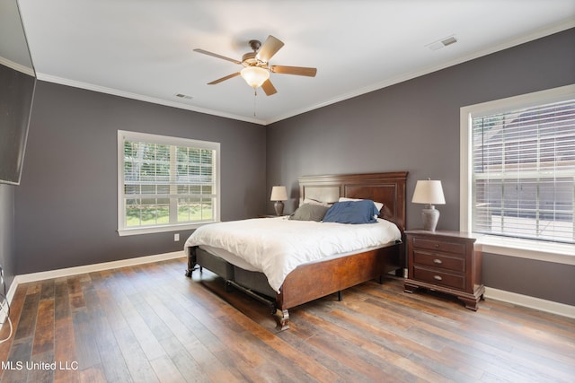 bedroom featuring hardwood / wood-style floors, ceiling fan, and crown molding