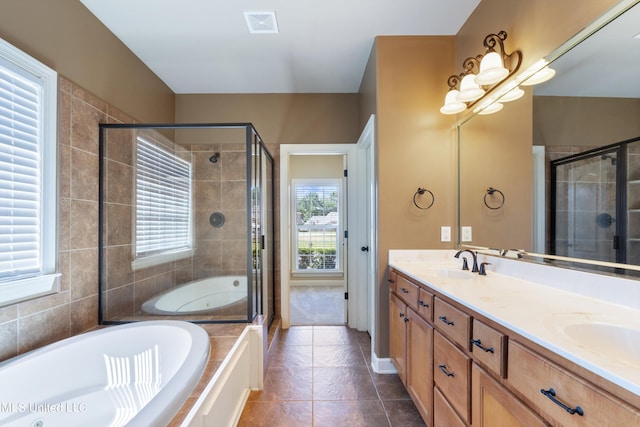 bathroom with tile patterned flooring, vanity, and plus walk in shower