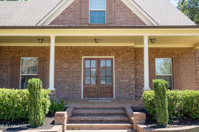 view of exterior entry featuring a porch and french doors