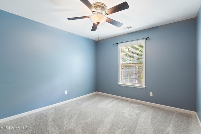 spare room with carpet and ceiling fan