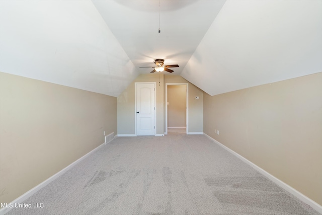 bonus room with light colored carpet, ceiling fan, and vaulted ceiling