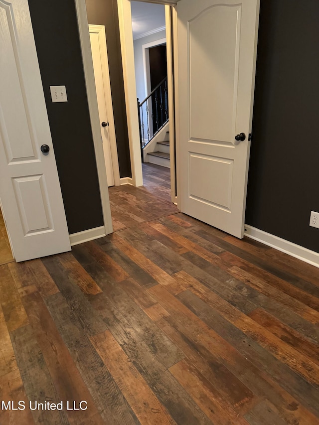 interior space featuring ornamental molding and dark hardwood / wood-style flooring