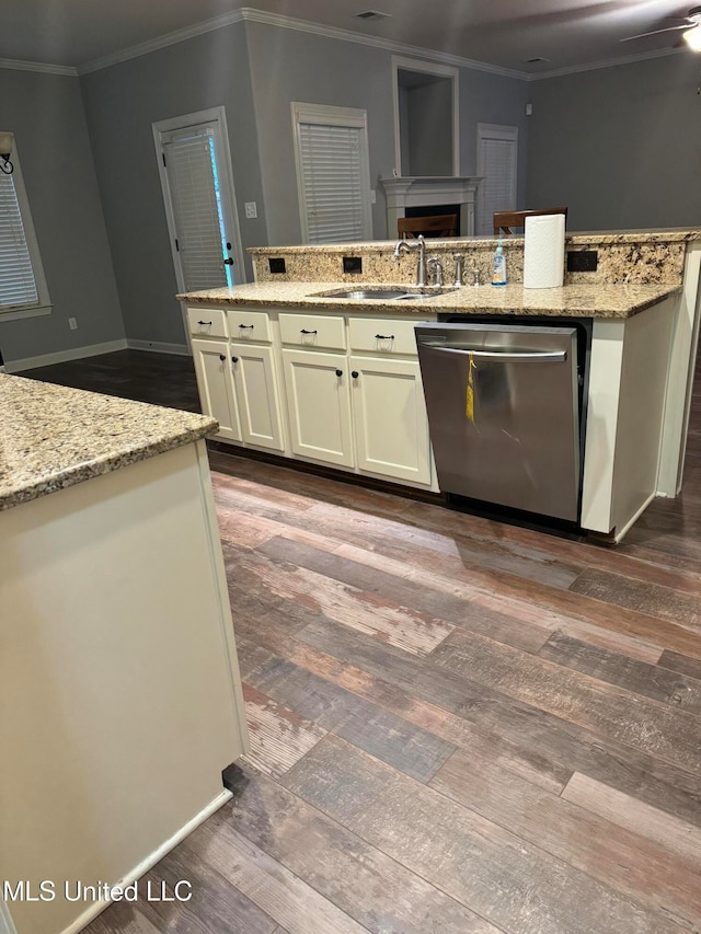 kitchen with light stone countertops, stainless steel dishwasher, sink, and dark hardwood / wood-style floors