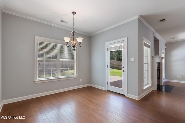 unfurnished dining area featuring an inviting chandelier, dark hardwood / wood-style floors, and crown molding