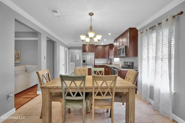 dining room featuring light tile patterned floors, a chandelier, and ornamental molding