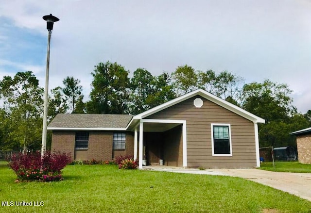 ranch-style home with a front lawn and brick siding