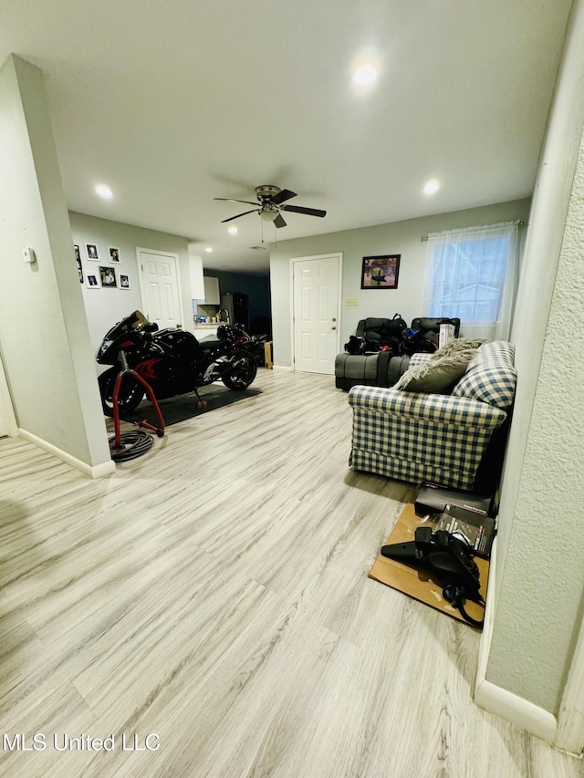 living room with recessed lighting, wood finished floors, a ceiling fan, and baseboards