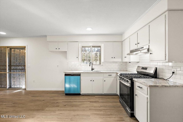 1399 Dorgan St, Jackson, MS 39204 - kitchen featuring sink, white cabinets, light wood-type flooring, and appliances with stainless steel finishes