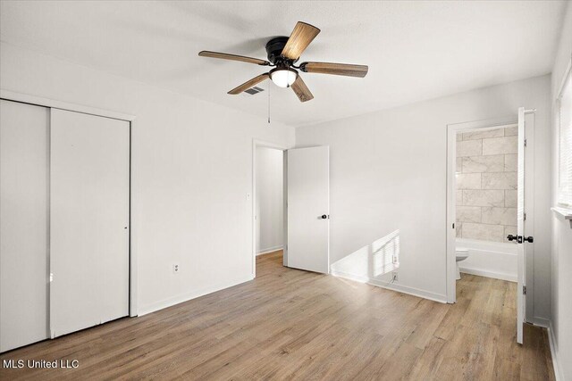1399 Dorgan St, Jackson, MS 39204 - unfurnished bedroom with light wood-type flooring, ensuite bathroom, a closet, and ceiling fan