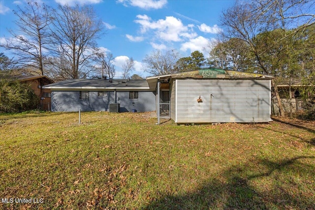 1399 Dorgan St, Jackson, MS 39204 - rear view of property featuring central air condition unit and a yard