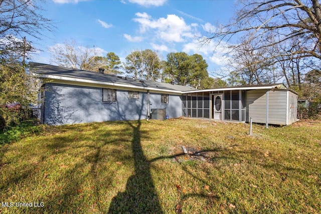 1399 Dorgan St, Jackson, MS 39204 - back of house featuring a sunroom, a yard, and central AC