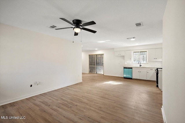 1399 Dorgan St, Jackson, MS 39204 - unfurnished living room featuring ceiling fan, sink, and light hardwood / wood-style flooring