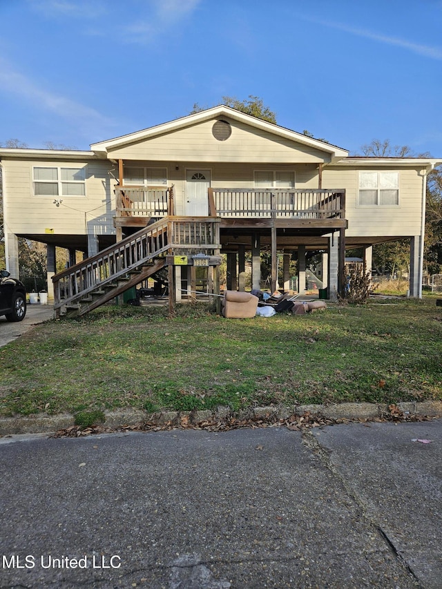 rear view of house with a yard and a deck