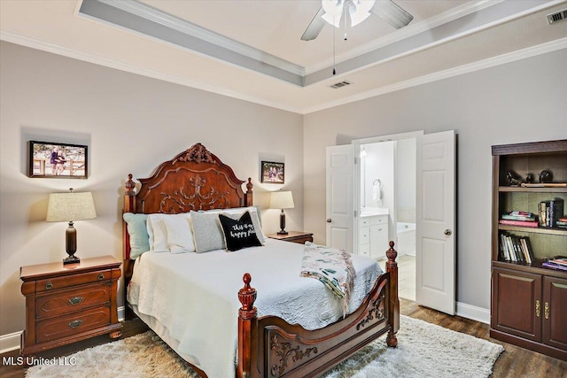 115 Victoria Pl, Brandon, MS 39042 - bedroom featuring a raised ceiling, dark wood finished floors, crown molding, connected bathroom, and ceiling fan