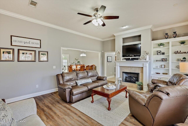 115 Victoria Pl, Brandon, MS 39042 - living room with wood finished floors, a ceiling fan, crown molding, baseboards, and a tiled fireplace