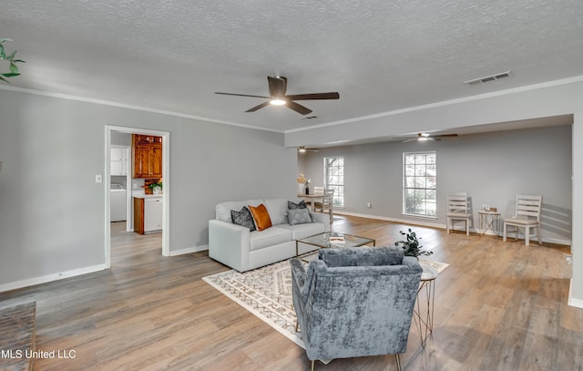 114 Fern Valley Rd, Brandon, MS 39042 - living area featuring ceiling fan, a textured ceiling, washer / clothes dryer, crown molding, and light wood finished floors