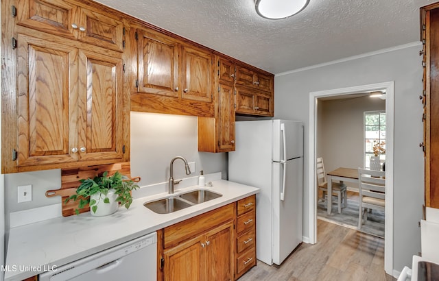 114 Fern Valley Rd, Brandon, MS 39042 - kitchen featuring white appliances, a sink, light wood-style floors, light countertops, and a textured ceiling