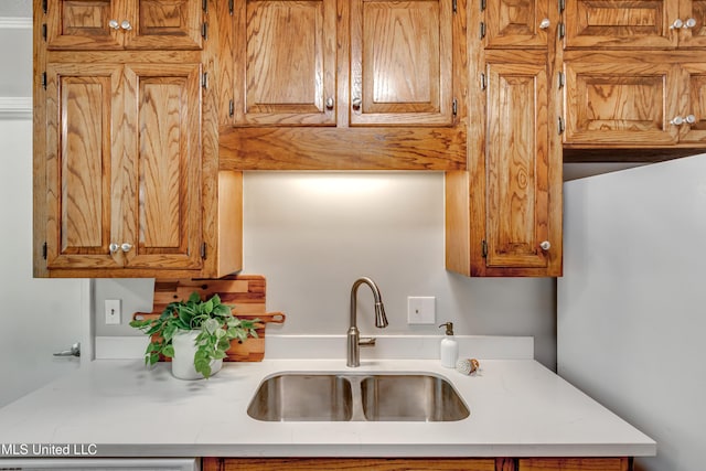 114 Fern Valley Rd, Brandon, MS 39042 - kitchen with a sink, light countertops, and brown cabinetry