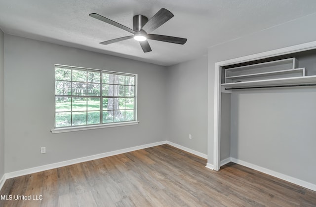 114 Fern Valley Rd, Brandon, MS 39042 - unfurnished bedroom with wood finished floors, a closet, baseboards, and a ceiling fan