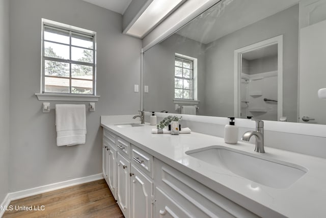 114 Fern Valley Rd, Brandon, MS 39042 - full bathroom with wood finished floors, double vanity, baseboards, a shower, and toilet