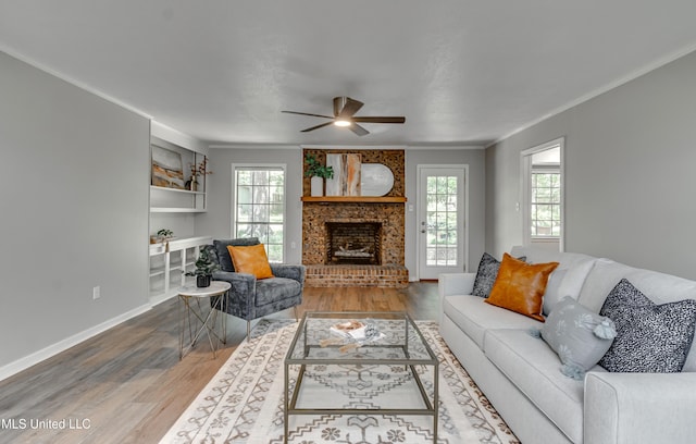 114 Fern Valley Rd, Brandon, MS 39042 - living room with healthy amount of natural light, wood finished floors, a ceiling fan, a fireplace, and crown molding