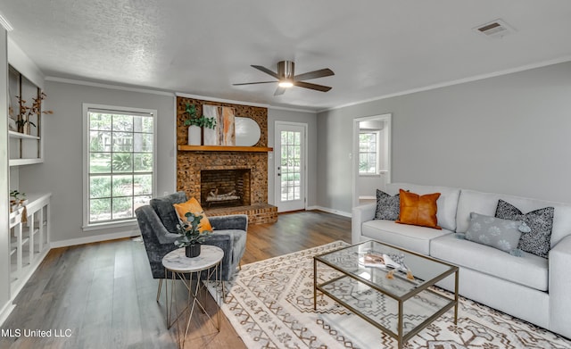 114 Fern Valley Rd, Brandon, MS 39042 - living area with wood finished floors, a ceiling fan, a large fireplace, crown molding, and baseboards