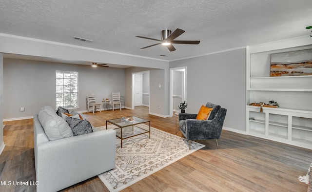 114 Fern Valley Rd, Brandon, MS 39042 - living area with a ceiling fan, a textured ceiling, wood finished floors, baseboards, and ornamental molding