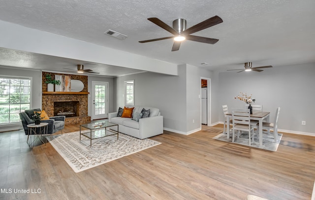 114 Fern Valley Rd, Brandon, MS 39042 - living room featuring a ceiling fan, wood finished floors, a textured ceiling, and baseboards