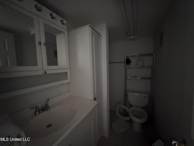 206 C St, Brandon, MS 39042 - bathroom featuring a sink, tile patterned flooring, and toilet