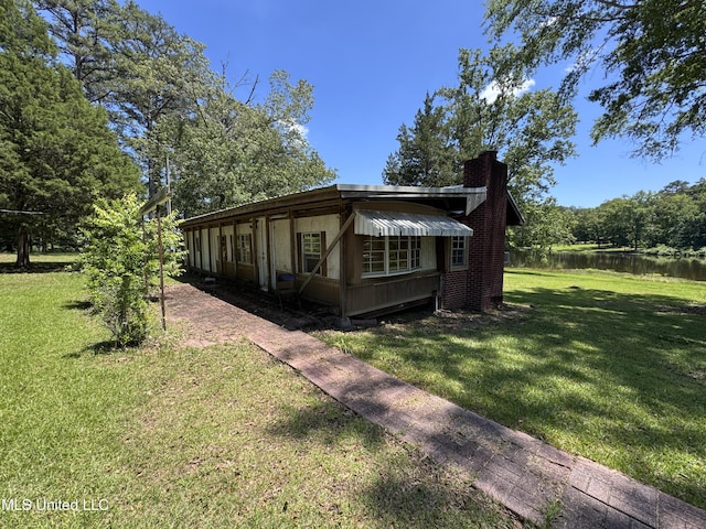 206 C St, Brandon, MS 39042 - view of property exterior featuring a chimney, a lawn, and a water view