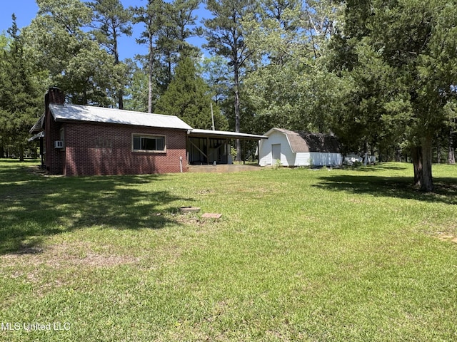 206 C St, Brandon, MS 39042 - view of green lawn with a shed, an outbuilding, view of scattered trees, and an attached carport