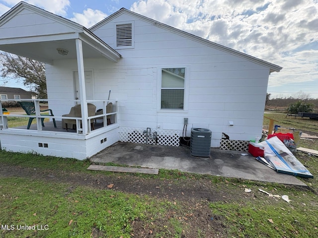 rear view of house with a patio and central AC