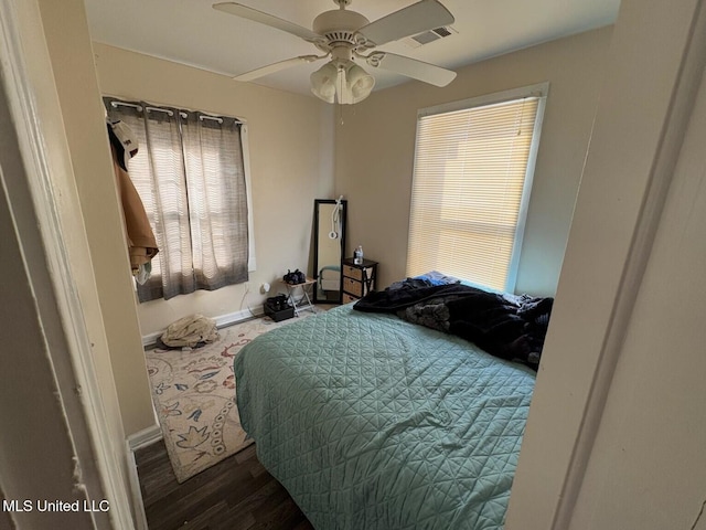 bedroom with ceiling fan and dark hardwood / wood-style flooring