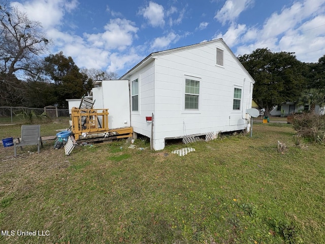 view of home's exterior with a lawn