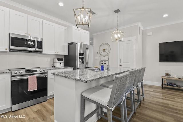 56 Oak Alley Ln, Long Beach, MS 39560 - kitchen featuring stainless steel appliances, a chandelier, light wood finished floors, crown molding, and white cabinetry